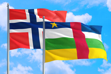 Central African Republic and Bouvet Islands national flag waving in the windy deep blue sky. Diplomacy and international relations concept.