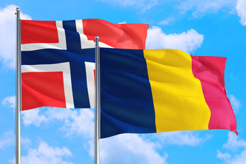 Chad and Bouvet Islands national flag waving in the windy deep blue sky. Diplomacy and international relations concept.