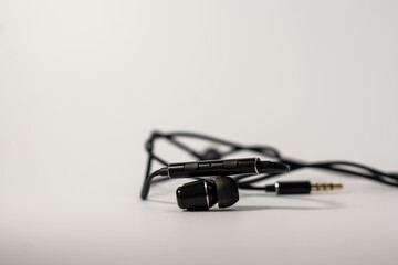 Black headphones with a microphone on a white background