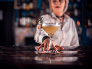 Young barmaid demonstrates his professional skills on the bar