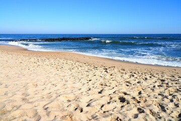Fototapeta na wymiar View of the beach in Belmar, New Jersey, along the long Jersey Shore beach on the Atlantic Ocean