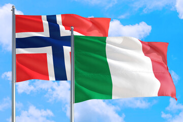 Italy and Bouvet Islands national flag waving in the windy deep blue sky. Diplomacy and international relations concept.