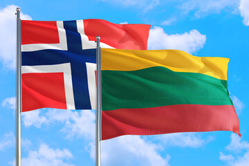 Lithuania and Bouvet Islands national flag waving in the windy deep blue sky. Diplomacy and international relations concept.