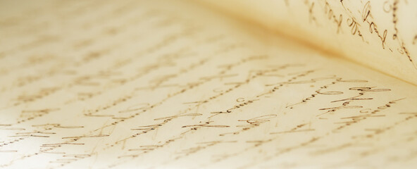 closeup of old handwriting; vintage paper background