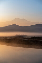 Sunrise with the mist over the river and the plain in Kayseri, in front of Erciyes mountain