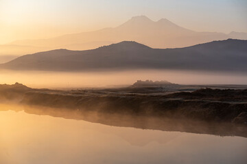 Sunrise with the mist over the river and the plain in Kayseri, in front of Erciyes mountain