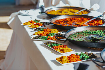 Tasting plate with various types of typical Valencian rice paellas, Spanish food.