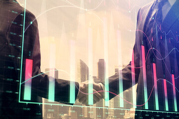Double exposure of forex graph hologram and handshake of two men. Stock market concept.