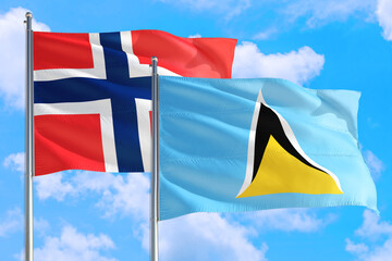 Saint Lucia and Bouvet Islands national flag waving in the windy deep blue sky. Diplomacy and international relations concept.