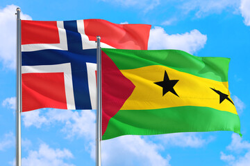 Sao Tome And Principe and Bouvet Islands national flag waving in the windy deep blue sky. Diplomacy and international relations concept.