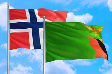 Zambia and Bouvet Islands national flag waving in the windy deep blue sky. Diplomacy and international relations concept.