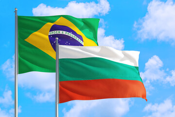 Burkina Faso and Brazil national flag waving in the windy deep blue sky. Diplomacy and international relations concept.