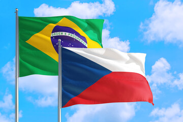 Denmark and Brazil national flag waving in the windy deep blue sky. Diplomacy and international relations concept.