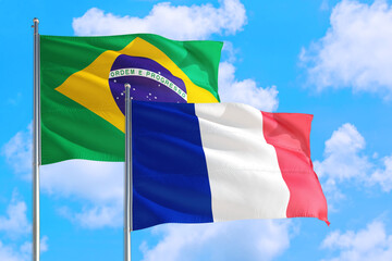 French Guiana and Brazil national flag waving in the windy deep blue sky. Diplomacy and international relations concept.