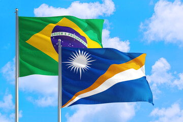 Martinique and Brazil national flag waving in the windy deep blue sky. Diplomacy and international relations concept.