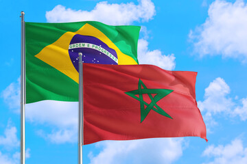 Mozambique and Brazil national flag waving in the windy deep blue sky. Diplomacy and international...