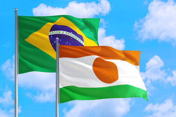 Nigeria and Brazil national flag waving in the windy deep blue sky. Diplomacy and international relations concept.
