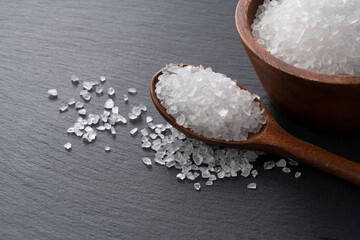 Himalayan rock salt and mint on a black background