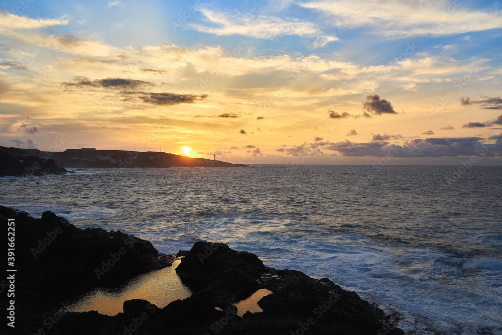 Poster beautiful shot of foam waves hitting a rocky seashore in gran canaria island