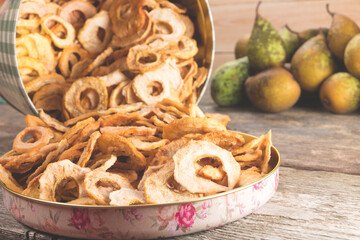 Dried pears on old wooden table in vintage style. Typical christmas sweets.