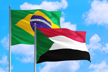Suriname and Brazil national flag waving in the windy deep blue sky. Diplomacy and international relations concept.