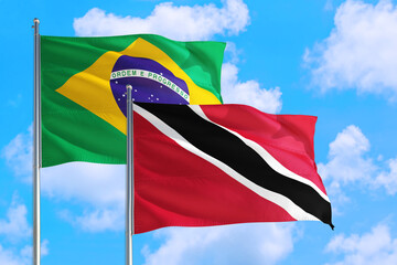 Tunisia and Brazil national flag waving in the windy deep blue sky. Diplomacy and international relations concept.