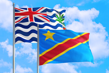 Congo and British Indian Ocean Territory national flag waving in blue sky. Diplomacy and international relations concept.