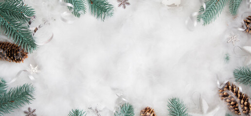 Flat lay winter header: spruce twigs in the snow with cristmas decoration with copy space