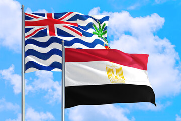 Egypt and British Indian Ocean Territory national flag waving in blue sky. Diplomacy and international relations concept.