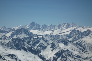 Fototapeta na wymiar De Izq. a Der. Vista de las Montañas Jungfrau - Monch y Eiger desde el monte Titlis, con un dia Azul totalmente despejado, tomada el 15-05-2012