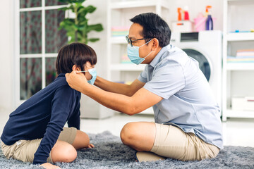 Portrait of enjoy happy love asian father wearing protective mask for little asian boy child in quarantine for coronavirus with social distancing at home.covid19 concept