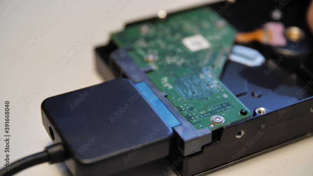 Poster close up of connecting a chip via an adapter to an external device. media. male hand connecting an a