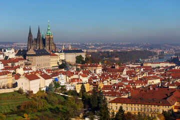 Obraz premium Autumn Prague City with gothic Castle and colorful Nature and Trees from the Hill Petrin, Czech Republic