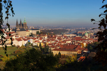 Obraz premium Autumn Prague City with gothic Castle and colorful Nature and Trees from the Hill Petrin, Czech Republic
