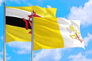 Vatican City and Brunei national flag waving in the windy deep blue sky. Diplomacy and...