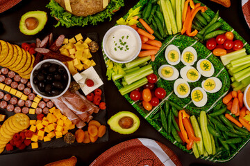 Table full of delicious snack for football game watching party.