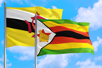 Zimbabwe and Brunei national flag waving in the windy deep blue sky. Diplomacy and international relations concept.