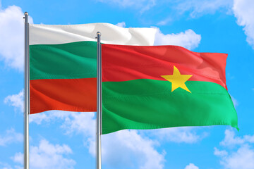 Burkina Faso and Bulgaria national flag waving in the windy deep blue sky. Diplomacy and international relations concept.