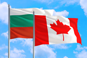 Canada and Bulgaria national flag waving in the windy deep blue sky. Diplomacy and international relations concept.