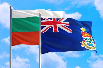 Cayman Islands and Bulgaria national flag waving in the windy deep blue sky. Diplomacy and international relations concept.