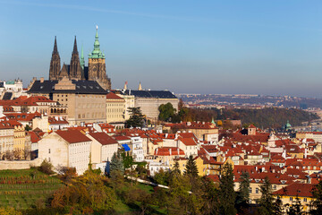 Obraz premium Autumn Prague City with gothic Castle and colorful Nature and Trees from the Hill Petrin, Czech Republic
