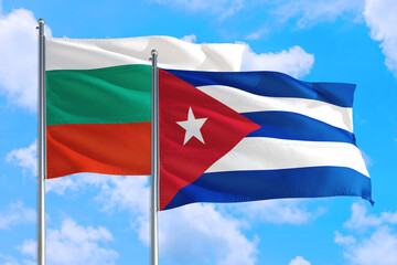 Cuba and Bulgaria national flag waving in the windy deep blue sky. Diplomacy and international relations concept.