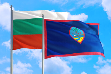Guam and Bulgaria national flag waving in the windy deep blue sky. Diplomacy and international relations concept.