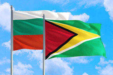 Guyana and Bulgaria national flag waving in the windy deep blue sky. Diplomacy and international relations concept.