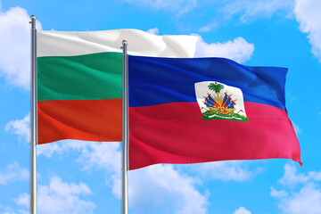 Haiti and Bulgaria national flag waving in the windy deep blue sky. Diplomacy and international relations concept.