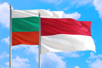 Monaco and Bulgaria national flag waving in the windy deep blue sky. Diplomacy and international relations concept.