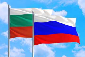 Russia and Bulgaria national flag waving in the windy deep blue sky. Diplomacy and international relations concept.