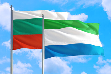 Sierra Leone and Bulgaria national flag waving in the windy deep blue sky. Diplomacy and international relations concept.