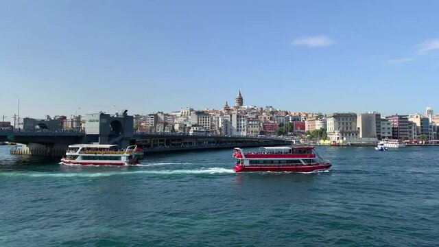 Footage of cruise tour boats on Golden Horn part of Bosphorus strait. Galata bridge, Karakoy and Beyoglu areas of Istanbul are in the view. Beautiful scene. It is a sunny summer day.