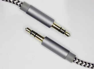 Fototapeta premium aux cable laying on white background